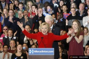Former U.S. President Bill Clinton (rear) applauds his wife, Democratic U.S. presidential candidate Hillary Clinton, as they appear with their daughter Chelsea (R) at Mrs. Clinton's caucus night rally in Des Moines, Iowa February 1, 2016. REUTERS/Adrees Latif
