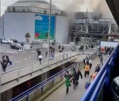 People flee from the Brussels airport in this image taken from video, shot by a bystander in the the immediate aftermath of blasts at the airport near Brussels, Belgium, March 22, 2016.  REUTERS/Asher  Gunsberg/Handout via Reuters TV