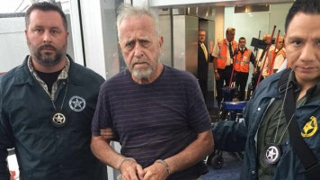 Nelson Sanderson was returned to the United States in Wednesday in the company of agents of the U.S. Marshals service.  He faces two life sentences if convicted. (Handout)